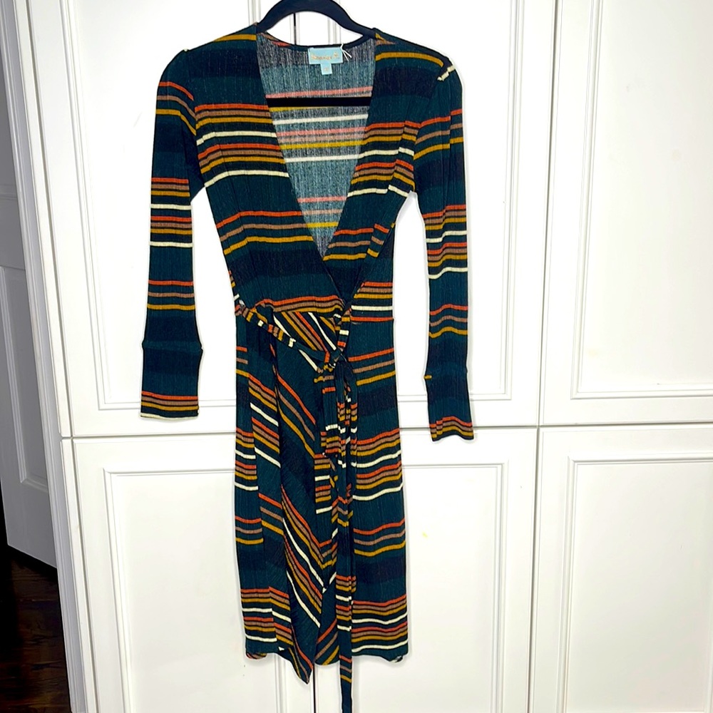 Veronica M.  Beautiful Wrap Dress.  Very flattering!!